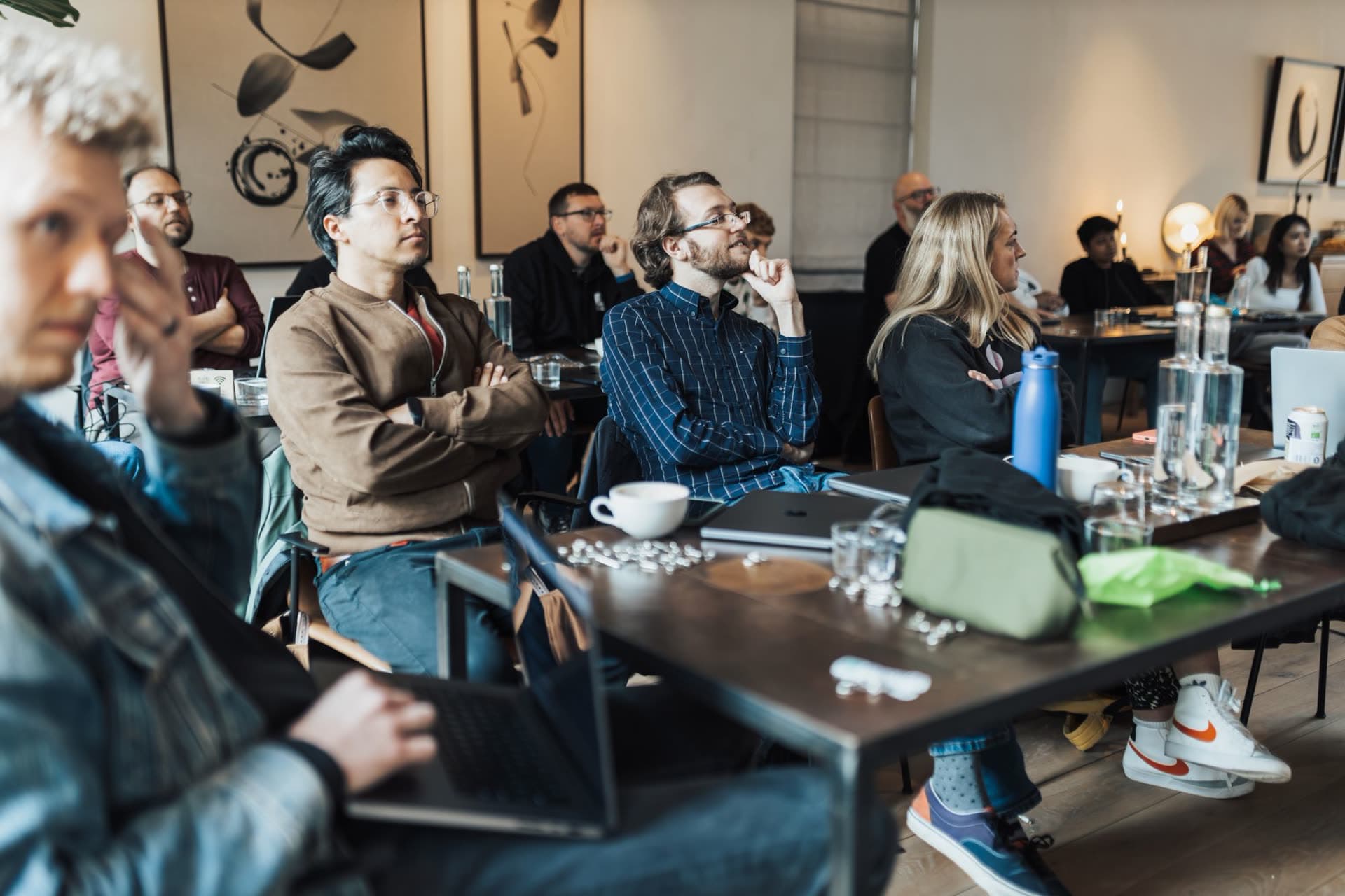Group taking an AI workshop with laptops at a work table